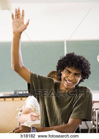 Male student in a classroom. View Large Photo Image Stock Image - Male student in a classroom.. Fotosearch