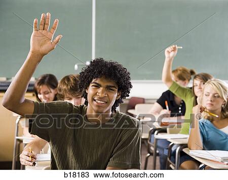 Stock Image - Male student in a classroom.. Fotosearch