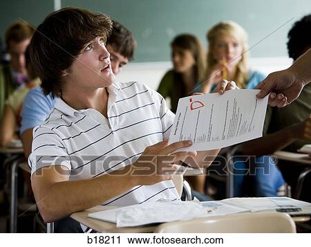 Male student in a classroom. View Large Photo Image Stock Image - Male student in a classroom.. Fotosearch