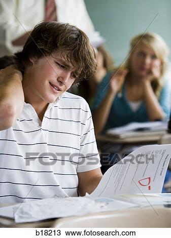 Male student in a classroom. View Large Photo Image Stock Image - Male student in a classroom.. Fotosearch