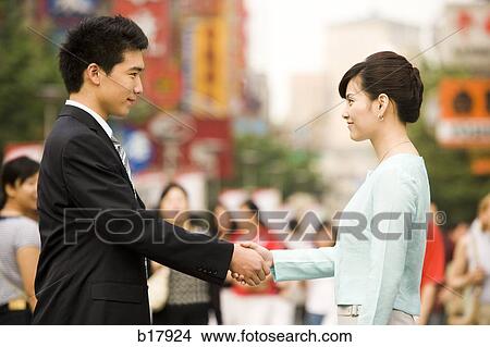 Picture - Man and a woman shaking hands.. Fotosearch