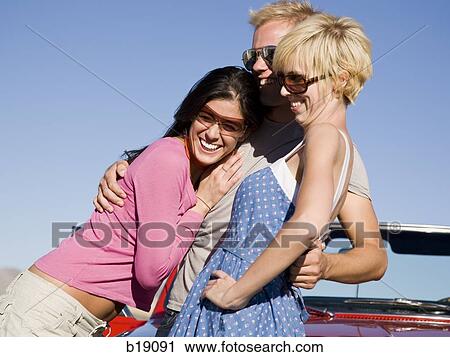 Stock Image - man and two woman.. Fotosearch