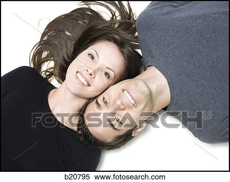 Stock Photography - man and woman lying head to head. Fotosearch