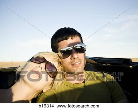 man and woman next to a red convertible View Large Photo Image Picture - man and woman next to a red convertible. Fotosearch