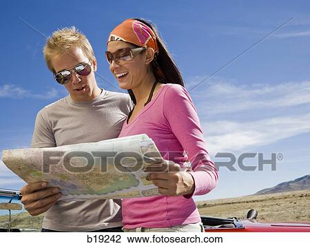 man and woman next to a red convertible View Large Photo Image Stock Image - man and woman next to a red convertible. Fotosearch