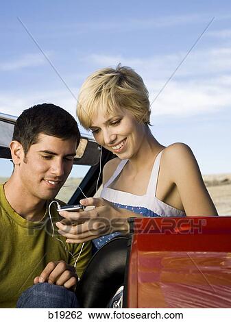 man and woman next to a red convertible View Large Photo Image Stock Image - man and woman next to a red convertible. Fotosearch