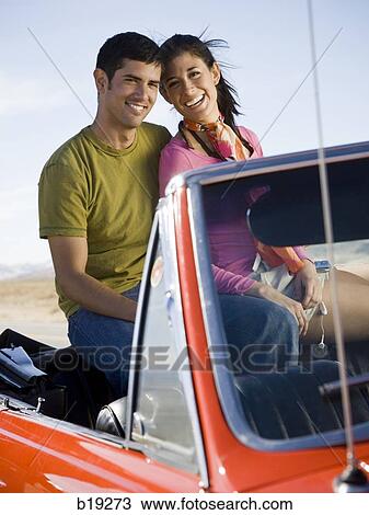 man and woman next to a red convertible View Large Photo Image Stock Image - man and woman next to a red convertible. Fotosearch