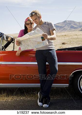 man and woman next to a red convertible View Large Photo Image Stock Photo - man and woman next to a red convertible. Fotosearch