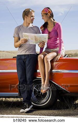 man and woman next to a red convertible View Large Photo Image Stock Photography - man and woman next to a red convertible. Fotosearch