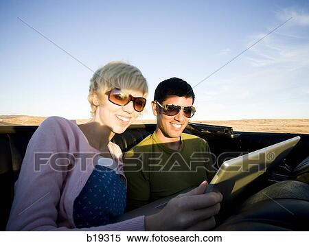 man and woman next to a red convertible View Large Photo Image Stock Photography - man and woman next to a red convertible. Fotosearch