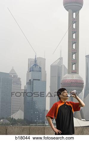 Man drinking bottled water. View Large Photo Image Picture - Man drinking bottled water.. Fotosearch