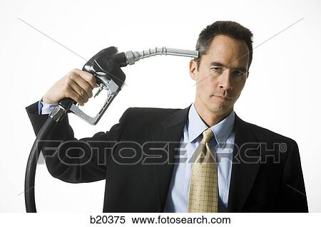 man holding a gas pump to his head View Large Photo Image Stock Photography - man holding a gas pump to his head. Fotosearch