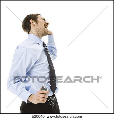 Stock Image - man listening to an mp3 player. Fotosearch