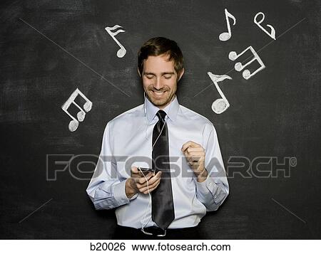 Stock Photograph - man listening to an mp3 player. Fotosearch