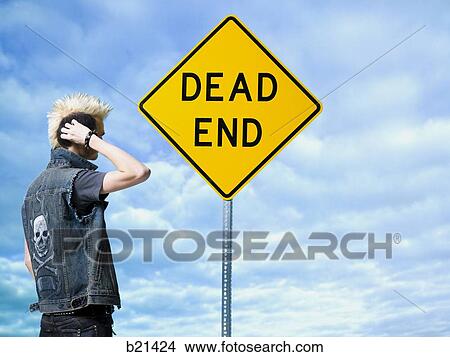 man looking at a dead end sign View Large Photo Image Picture - man looking at a dead end sign. Fotosearch
