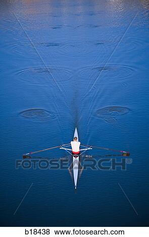 Man rowing on a body of water. View Large Photo Image Stock Photo - Man rowing on a body of water.. Fotosearch