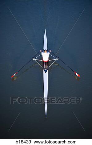Man rowing on a body of water. View Large Photo Image Stock Photo - Man rowing on a body of water.. Fotosearch