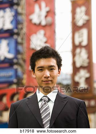 Man standing on a city street. View Large Photo Image Stock Photo - Man standing on a city street.. Fotosearch