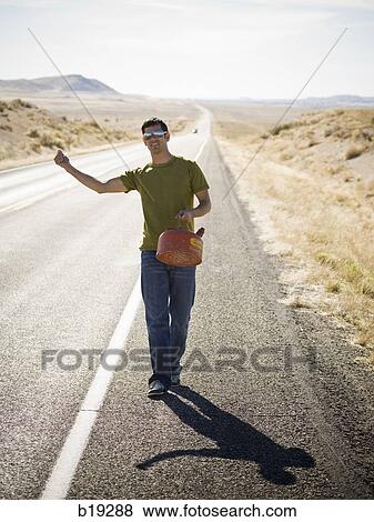 Stock Photo - man walking with a gas can. Fotosearch