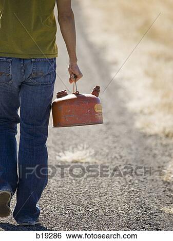 man walking with a gas can View Large Photo Image Stock Photograph - man walking with a gas can. Fotosearch