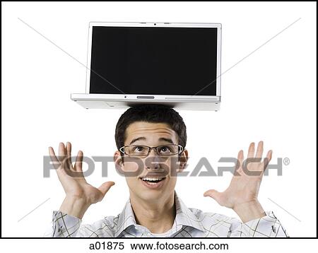 Stock Photography - man with laptop on his head. Fotosearch