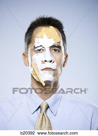 Stock Image - man with pie on his face. Fotosearch
