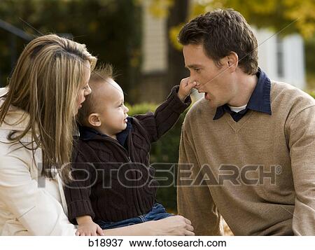 "man, woman, and baby in fallen leaves. " View Large Photo Image Stock Photo - "man, woman, and baby in fallen leaves. ". Fotosearch