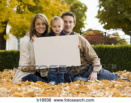 "man, woman, and baby in fallen leaves. " View Large Photo Image Stock Photo - "man, woman, and baby in fallen leaves. ". Fotosearch