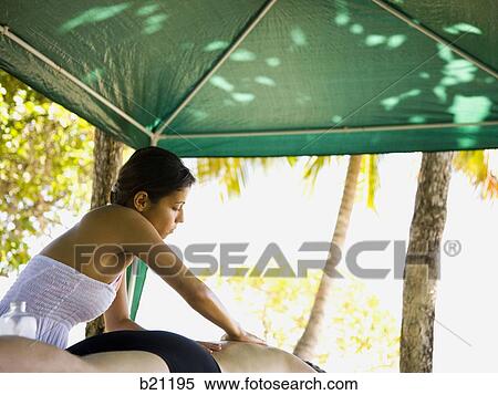 Stock Photography - massage on the beach. Fotosearch