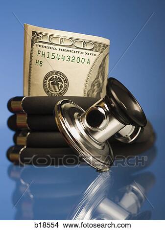 Money wrapped in a stethoscope. View Large Photo Image Picture - Money wrapped in a stethoscope.. Fotosearch