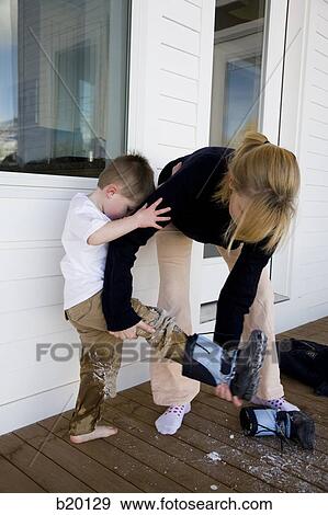 mother and child taking off boots View Large Photo Image Stock Photo - mother and child taking off boots. Fotosearch