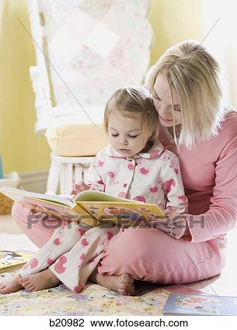 mother and daughter reading a book View Large Photo Image Stock Image - mother and daughter reading a book. Fotosearch
