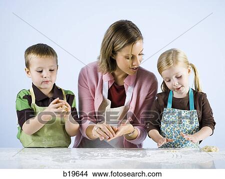 mother cooking with children View Large Photo Image Picture - mother cooking with children. Fotosearch