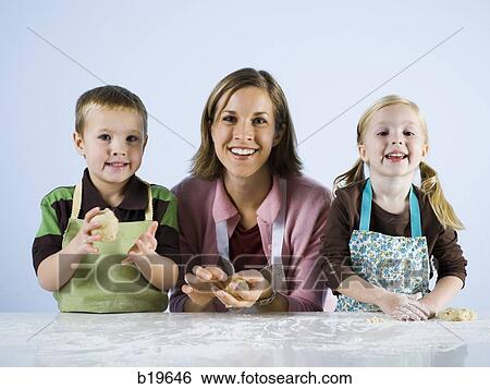 mother cooking with children View Large Photo Image Stock Photograph - mother cooking with children. Fotosearch