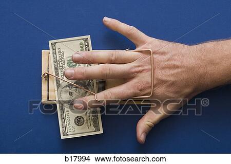 Mouse trap with money as bait. View Large Photo Image Picture - Mouse trap with money as bait.. Fotosearch