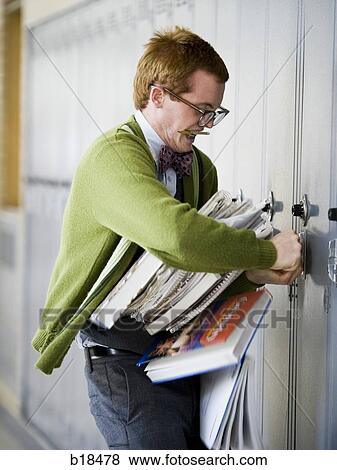Stock Photo - Nerd trying to open his locker.. Fotosearch
