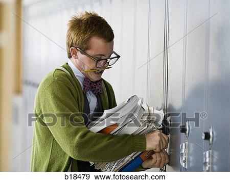 Stock Photo - Nerd trying to open his locker.. Fotosearch
