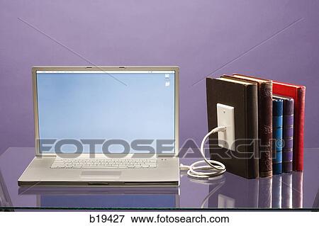 notebook computer plugged into books View Large Photo Image Stock Photo - notebook computer plugged into books. Fotosearch