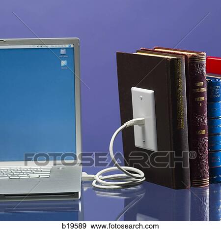 notebook computer plugged into books View Large Photo Image Stock Photo - notebook computer plugged into books. Fotosearch