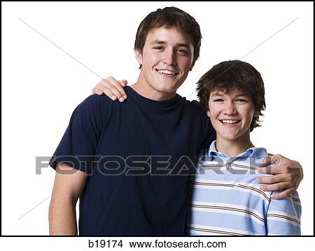 older boy with arm around younger boy. View Large Photo Image Picture - older boy with arm around younger boy.. Fotosearch