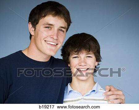 older boy with arm around younger boy. View Large Photo Image Stock Photo - older boy with arm around younger boy.. Fotosearch