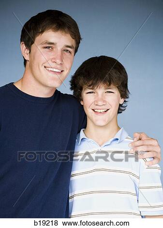 older boy with arm around younger boy. View Large Photo Image Stock Photo - older boy with arm around younger boy.. Fotosearch