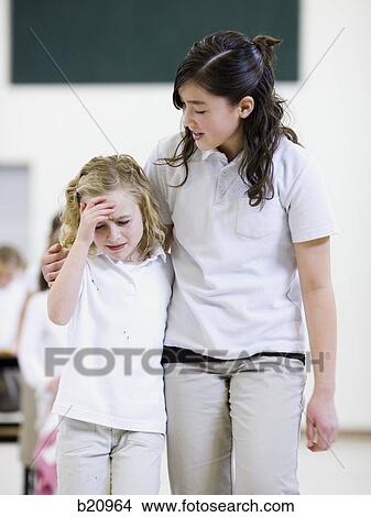 older girl comforting a younger girl View Large Photo Image Picture - older girl comforting a younger girl. Fotosearch