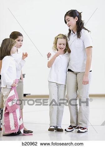 Stock Image - older girl comforting a younger girl. Fotosearch
