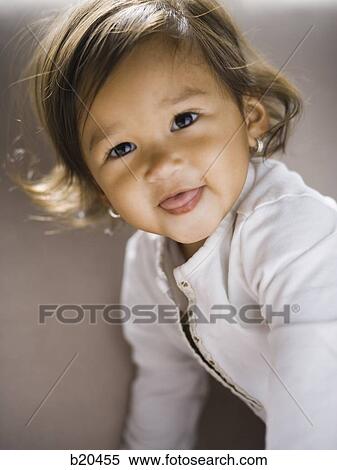 Stock Photography - One Baby Girl Only, Day, Mixed Race Person, Latin American and Hispanic Ethnicity, Indoors, One Person, 12-17 months. Fotosearch