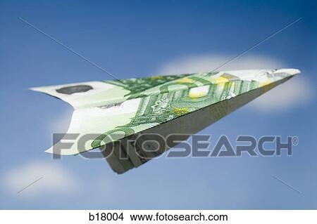 Paper airplane made out of money. View Large Photo Image Picture - Paper airplane made out of money.. Fotosearch