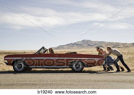 people pushing a car down the road View Large Photo Image Stock Image - people pushing a car down the road. Fotosearch