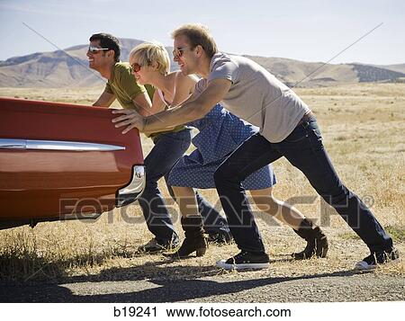 people pushing a car down the road View Large Photo Image Stock Image - people pushing a car down the road. Fotosearch