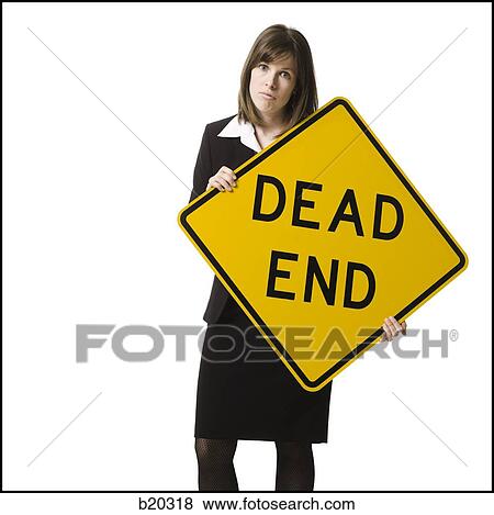 "person holding a ""dead end"" sign" View Large Photo Image Stock Photo - "person holding a ""dead end"" sign". Fotosearch