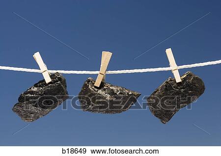 Pieces of coal on a clothes line. View Large Photo Image Stock Photo - Pieces of coal on a clothes line.. Fotosearch